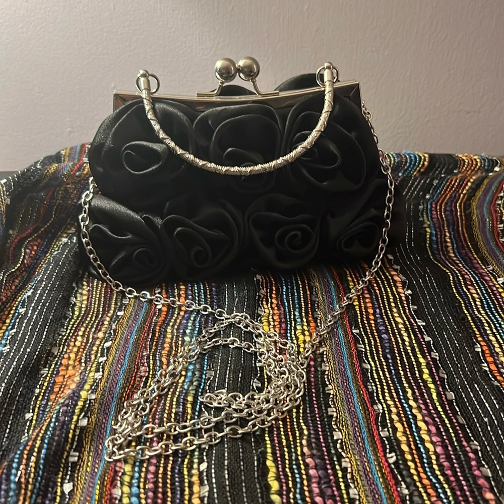 Black floral satin-like evening bag.